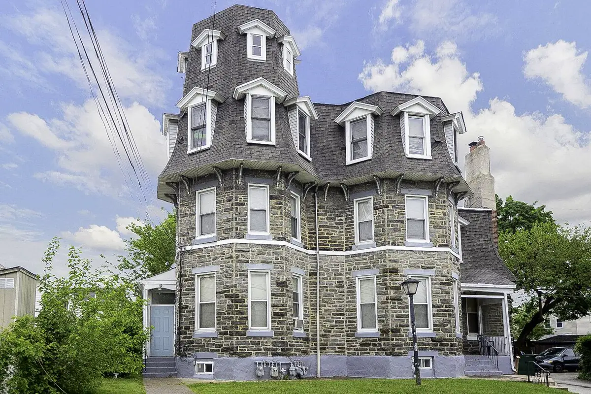 Stone rental property with a landscaped front lawn